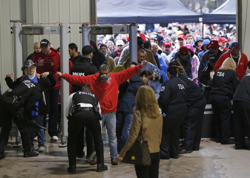 TSA and police inspect people entering a Trump rally in Bloomington, Illinois this morning (Associated Press)